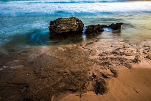 Vibrant coastal scene with rocky formations and blue ocean waves at Point Lonsdale, Australia.