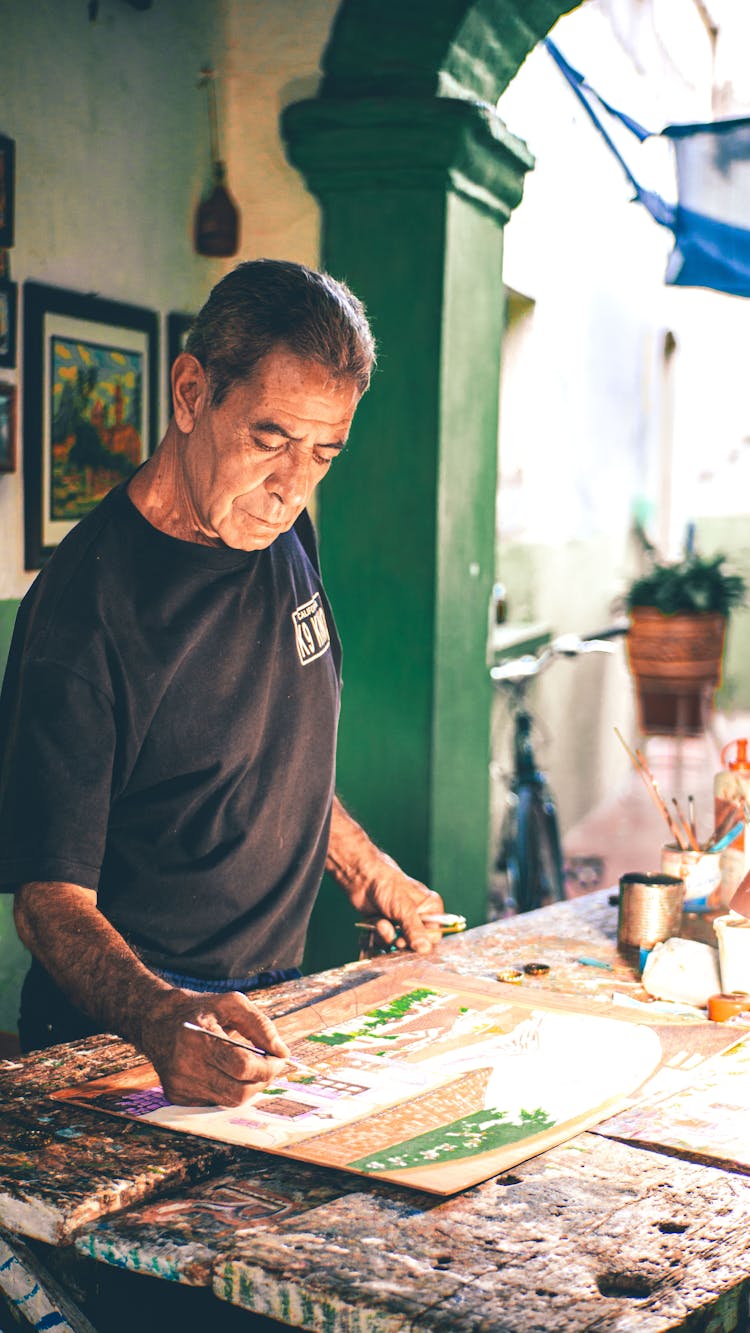 Man Standing And Painting