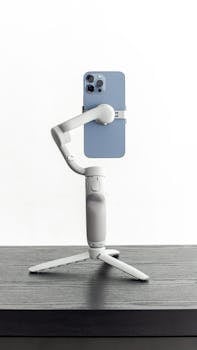 Side view of a smartphone mounted on a tripod stand, ideal for mobile photography.
