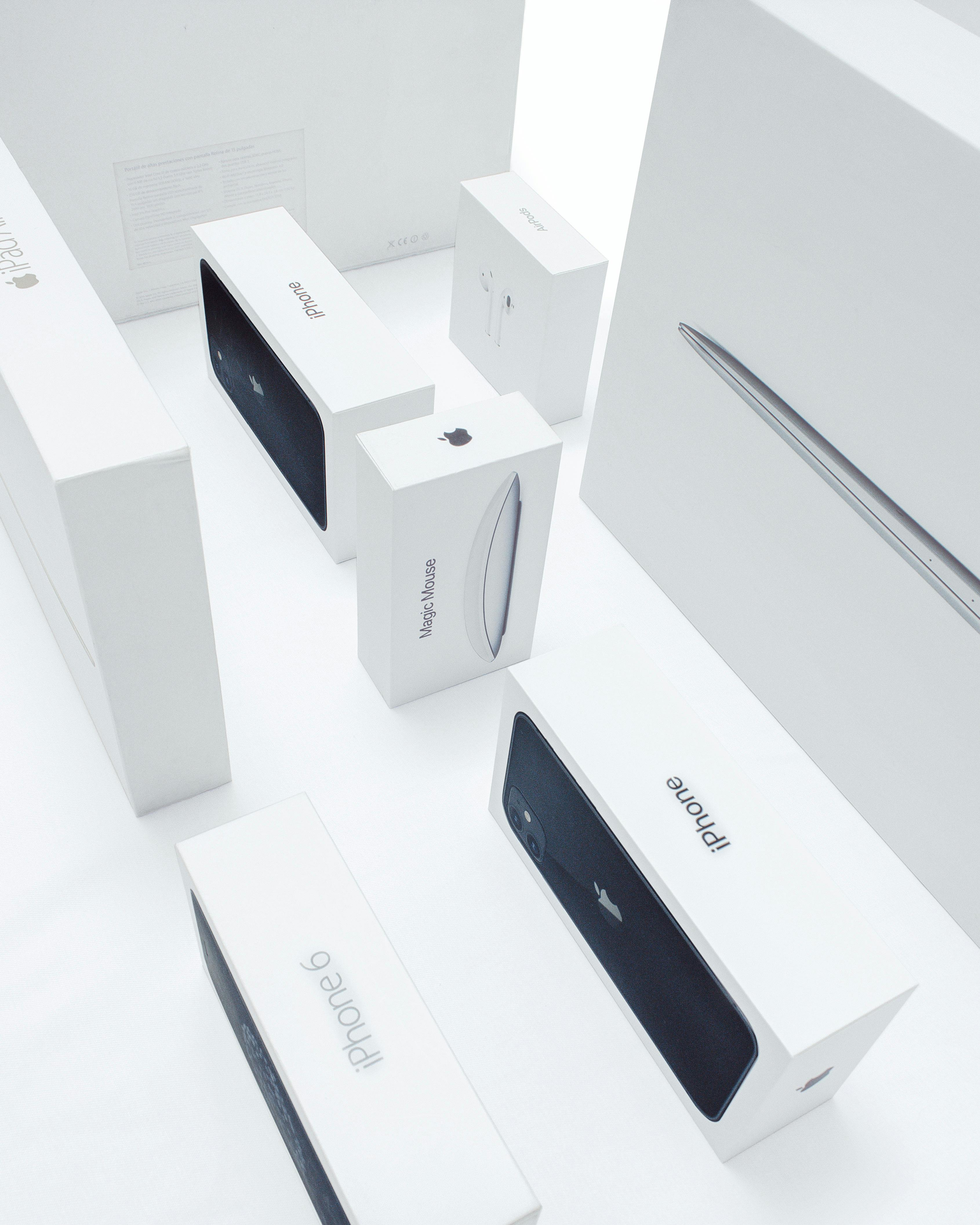 Boxes of Various Apple Products on a White Surface Free Stock Photo