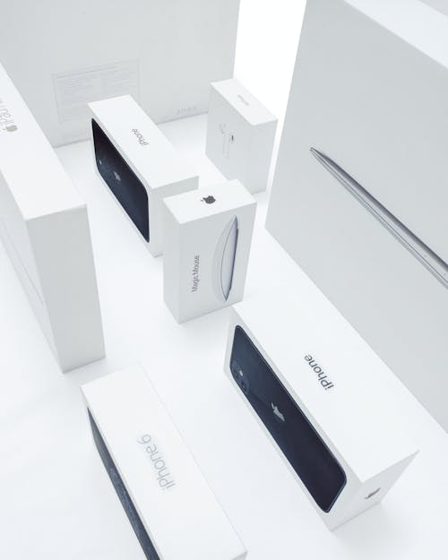 Boxes of Various Apple Products on a White Surface