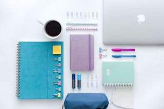 Blue and Pink Click Pens on White Notebook