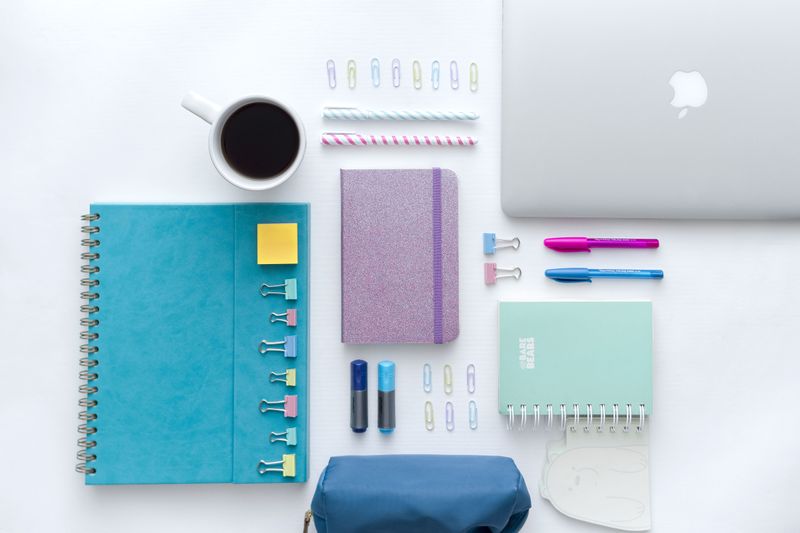 Colourful desk setup with notebooks and stationery — photo by Alan Quirvan on Pexels