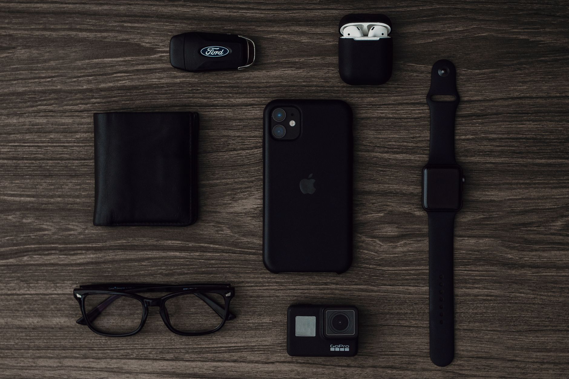 Flat lay of modern gadgets on wood surface, perfect for technology-themed projects.