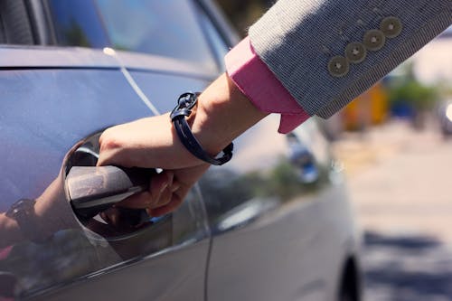 Photo of a Person Opening a Car Door