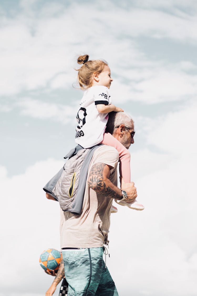 Man Carrying The Girl On His Shoulders 