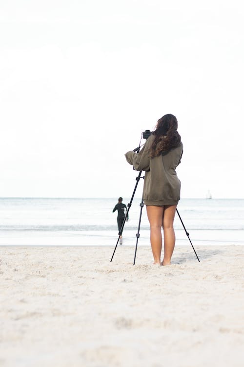 Woman Taking Photo on Beach