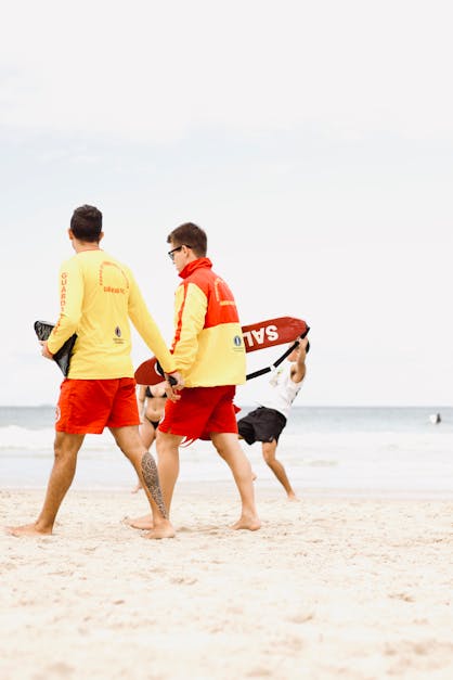 Lifeguards Walking on the Beach · Free Stock Photo
