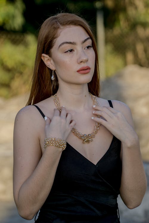 Woman Wearing Black Camisole And Gold Necklace 