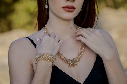 Free Woman Touching Gold Necklace Stock Photo