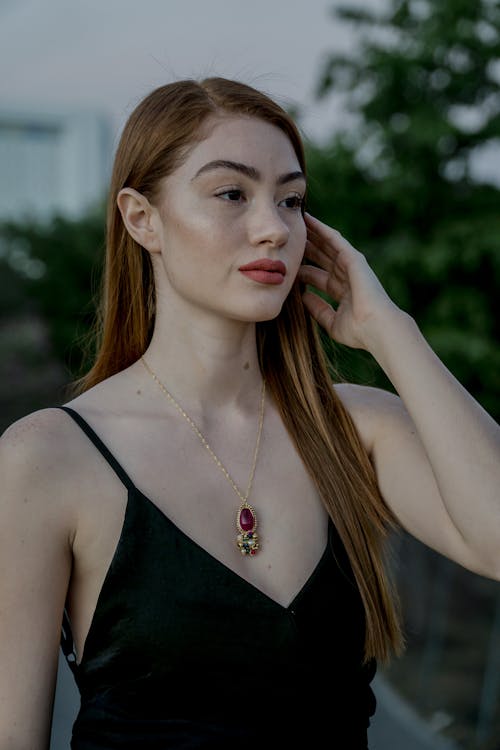 Photo of Woman in White Dress Shirt, Maroon Bra, and Blue Denim