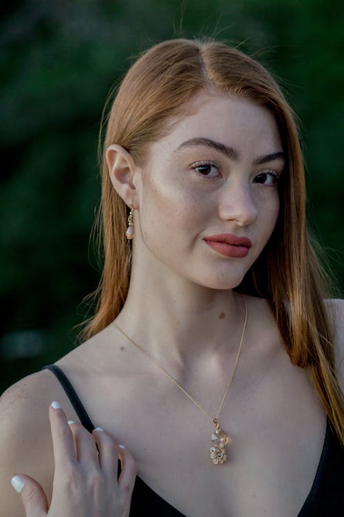 Free Close-up Photography Of Woman Wearing Gold Necklace Stock Photo