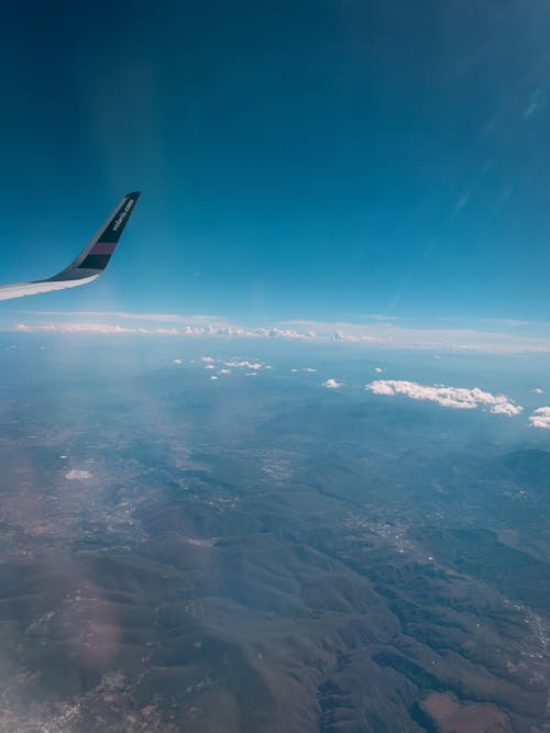 Airplane Wing and the View seen from an Airplane Window