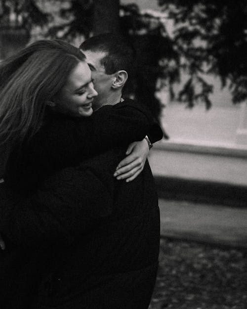 Grayscale Photo of a Couple Hugging