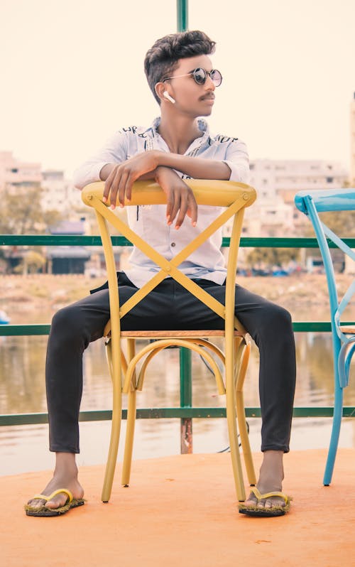 Man Sitting In A Chair In A Restaurant