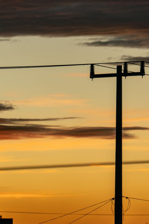 Free Silhouette of a power line during a vibrant sunset in San Mateo Atarasquillo, México. Stock Photo