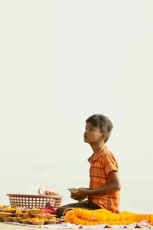 Side View of a Boy Kneeling on a Yellow Blanket