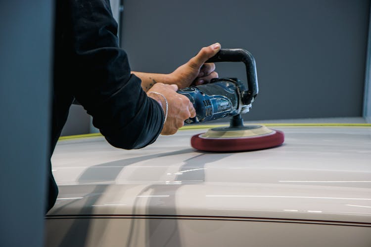 A Person Buffing A Car 