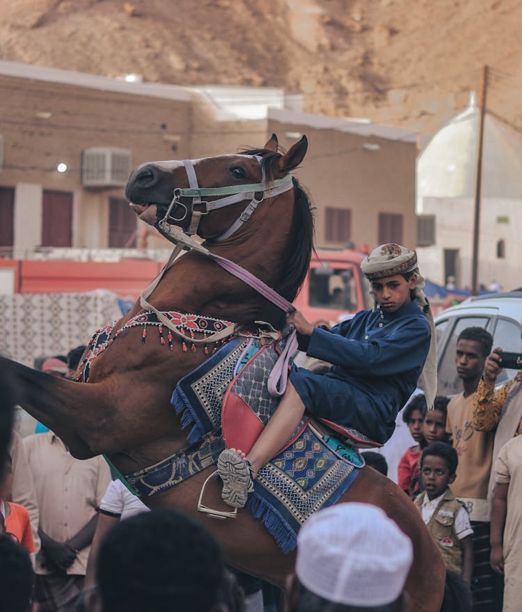 Boy Riding Horse In Town