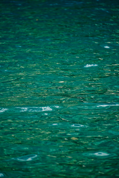 Free Calm emerald water surface with gentle ripples creating a soothing texture Stock Photo