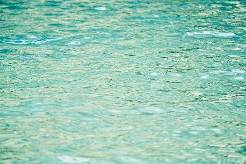 Free Illustration of still rippling turquoise water with light reflections and gentle waves. Stock Photo