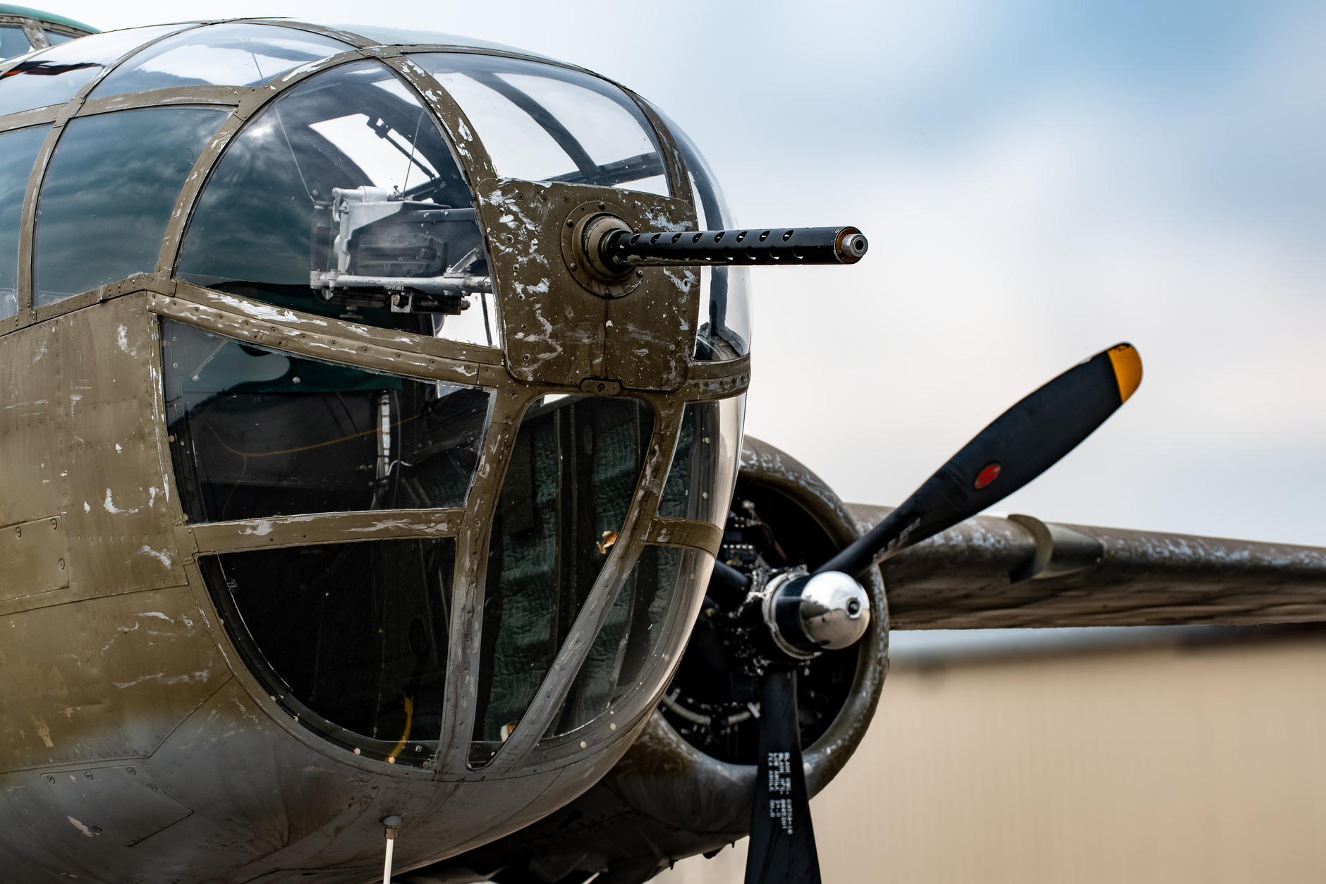 Detailed view of a vintage military aircraft nose and propeller. World War II era.