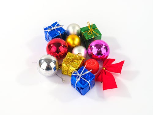 Close-Up Shot of Christmas Ornaments on White Surface