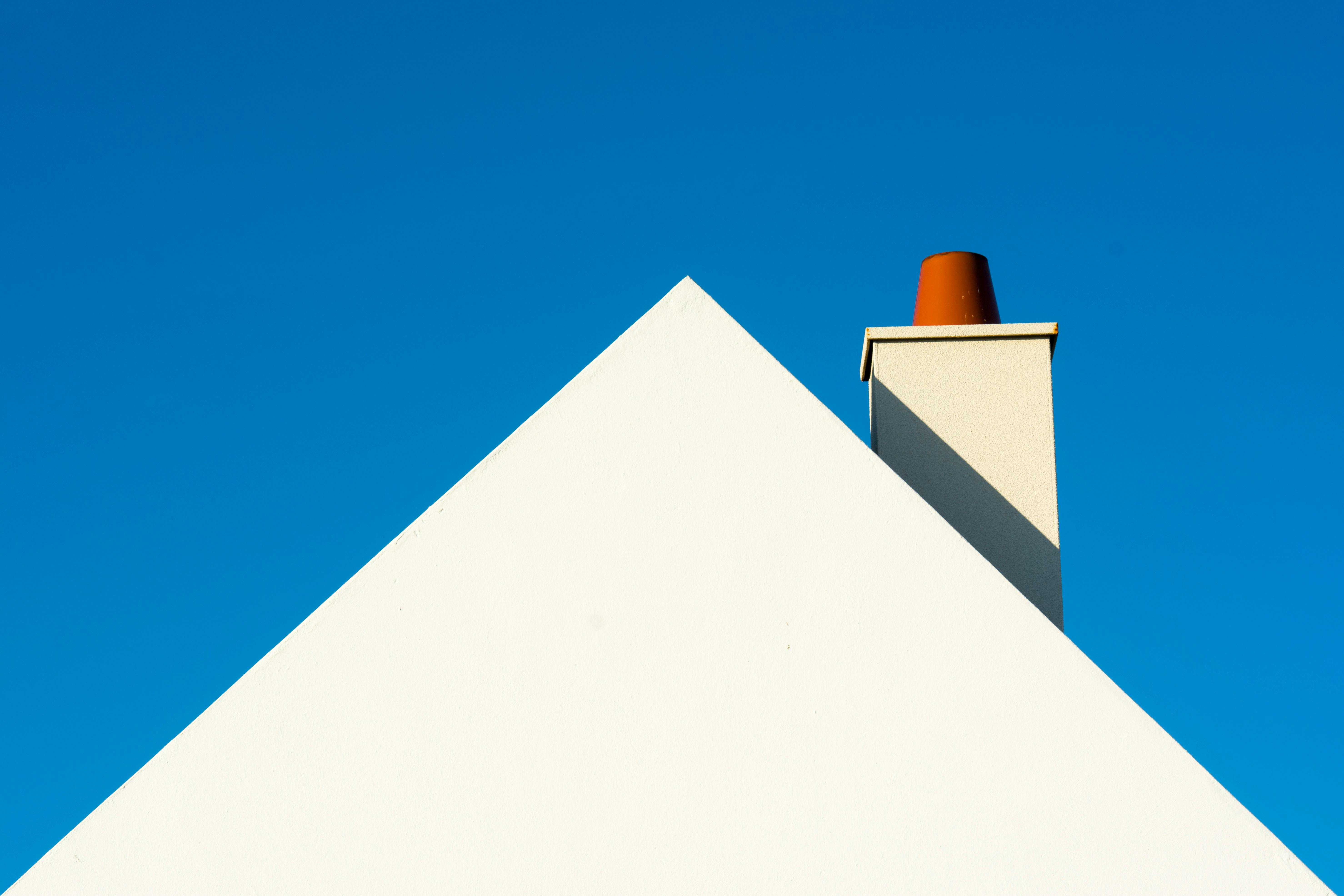 White Triangle House Roof with a Chimney · Free Stock Photo