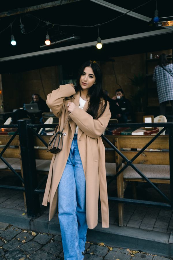 Woman in long coat and jeans, professional winter look