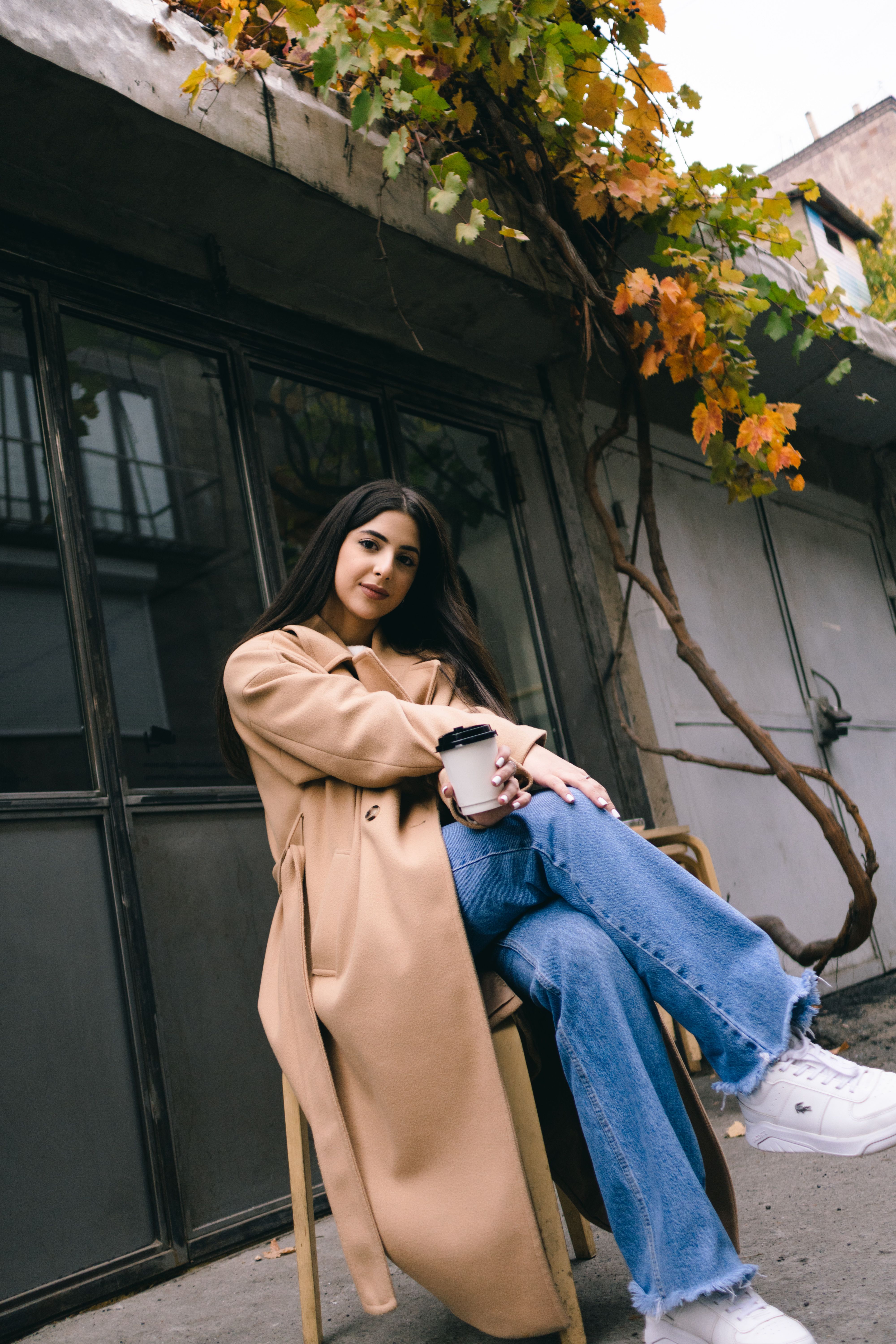 Beautiful Woman in Brown Coat Holding Cup of Coffee · Free Stock Photo