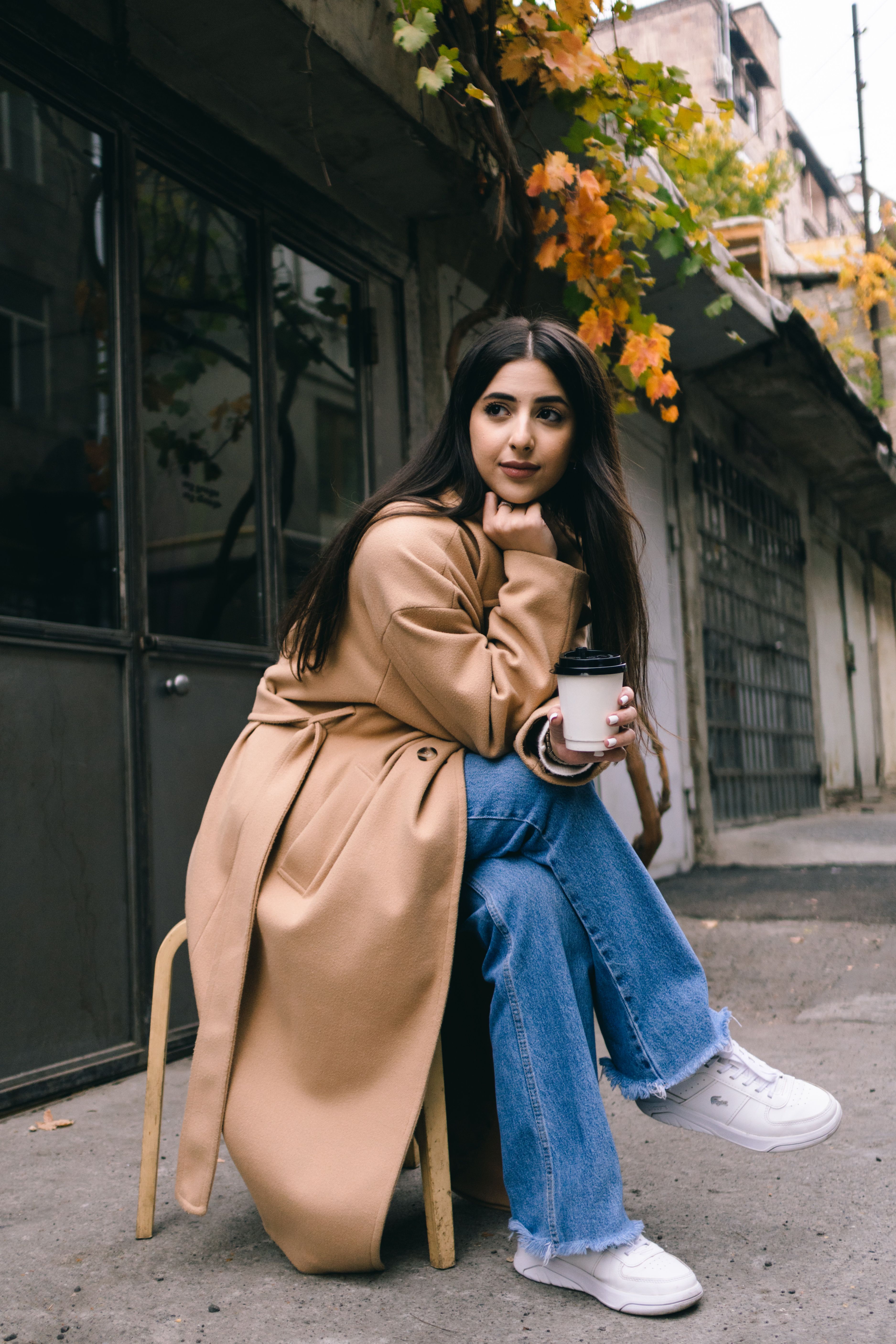 Woman in oversized beige coat with mom jeans