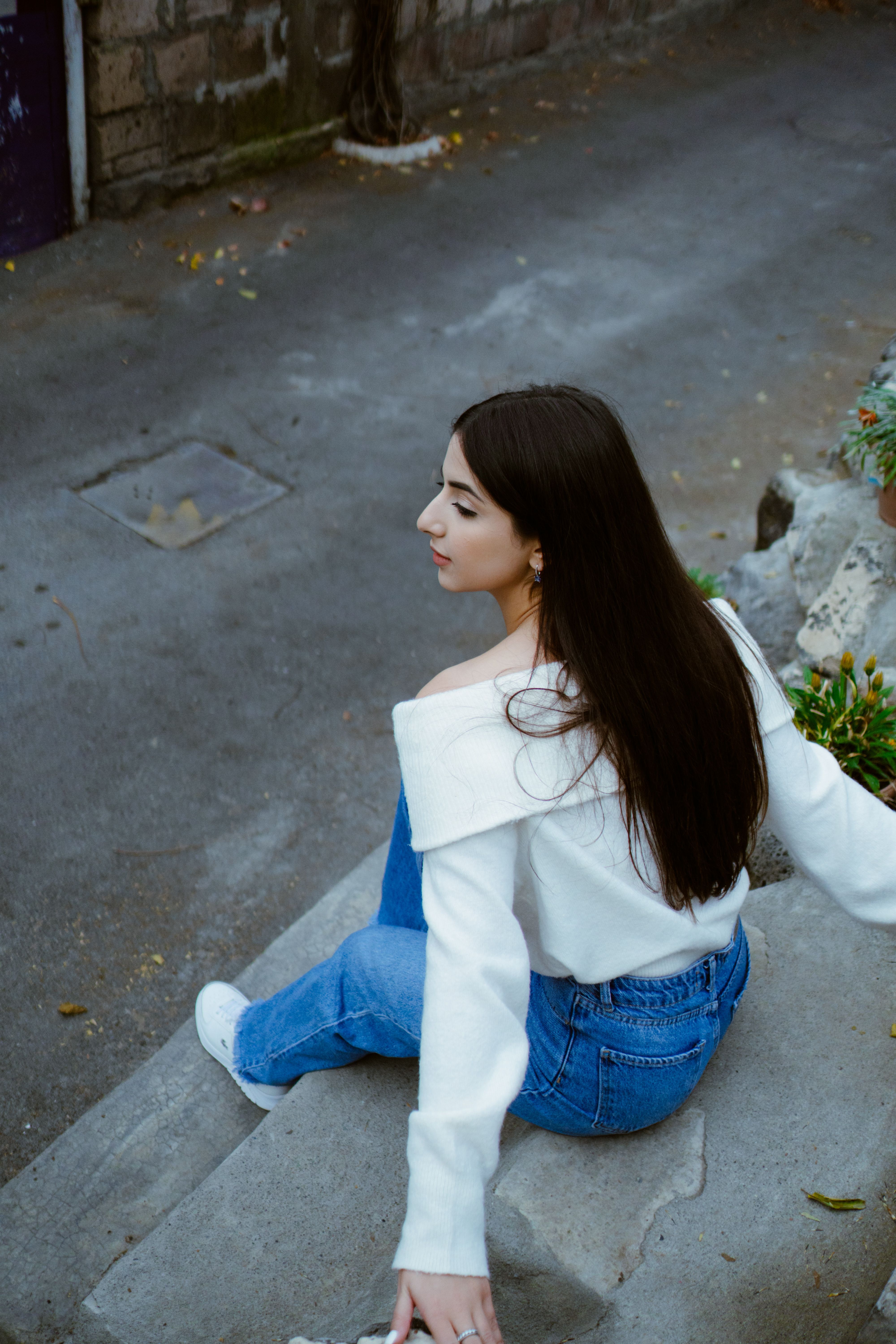 Woman in White Long Sleeve Shirt Sitting on Concrete Stairs · Free ...