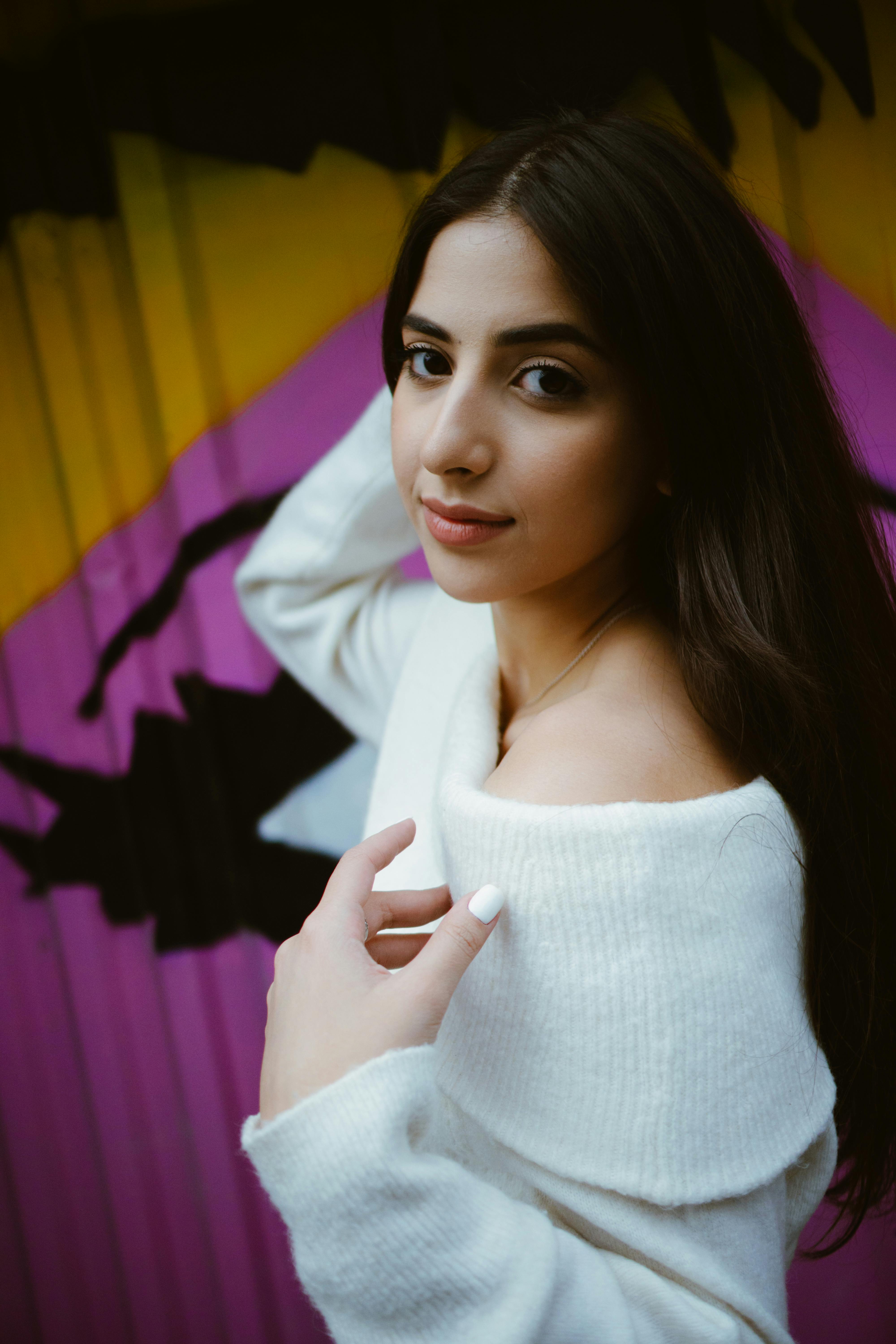 portrait photo of a beautiful woman in white off shoulder sweater