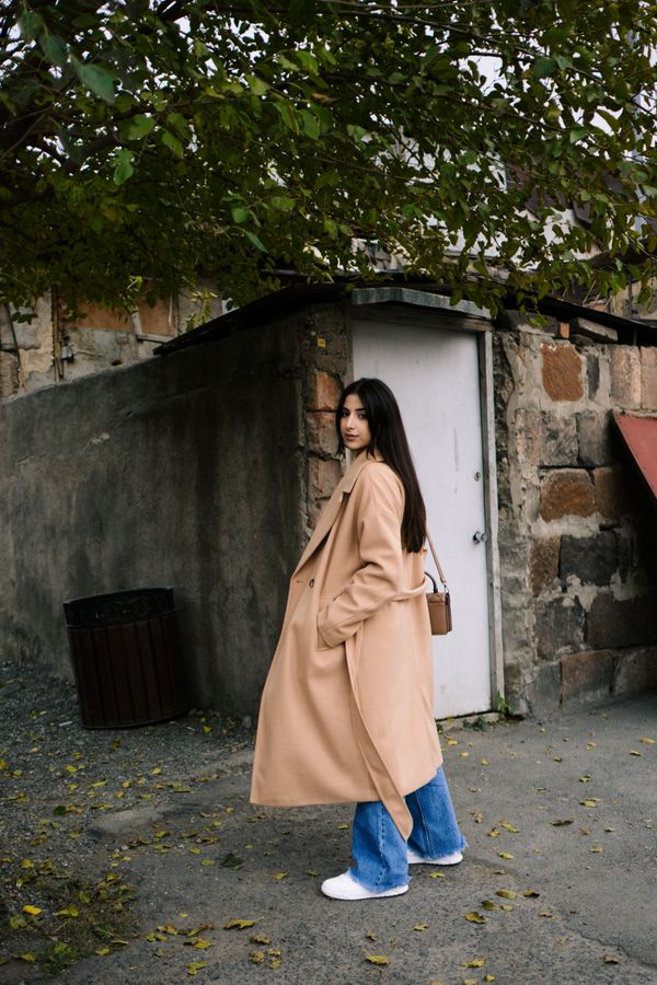 Woman in statement coat and jeans