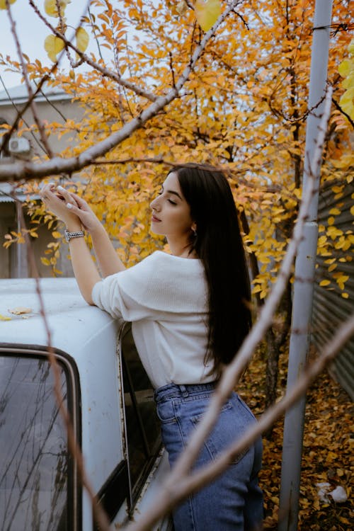 Brunette Woman by Car in Autumn