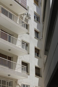 Close-up view of a modern residential building showcasing balconies and windows.