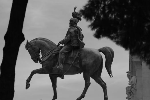 Grayscale Photo of a Statue of Man Riding Horse