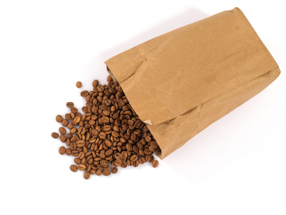 Brown paper bag of roasted coffee beans