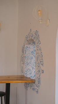 Minimalist interior featuring artful wall design with wood table.