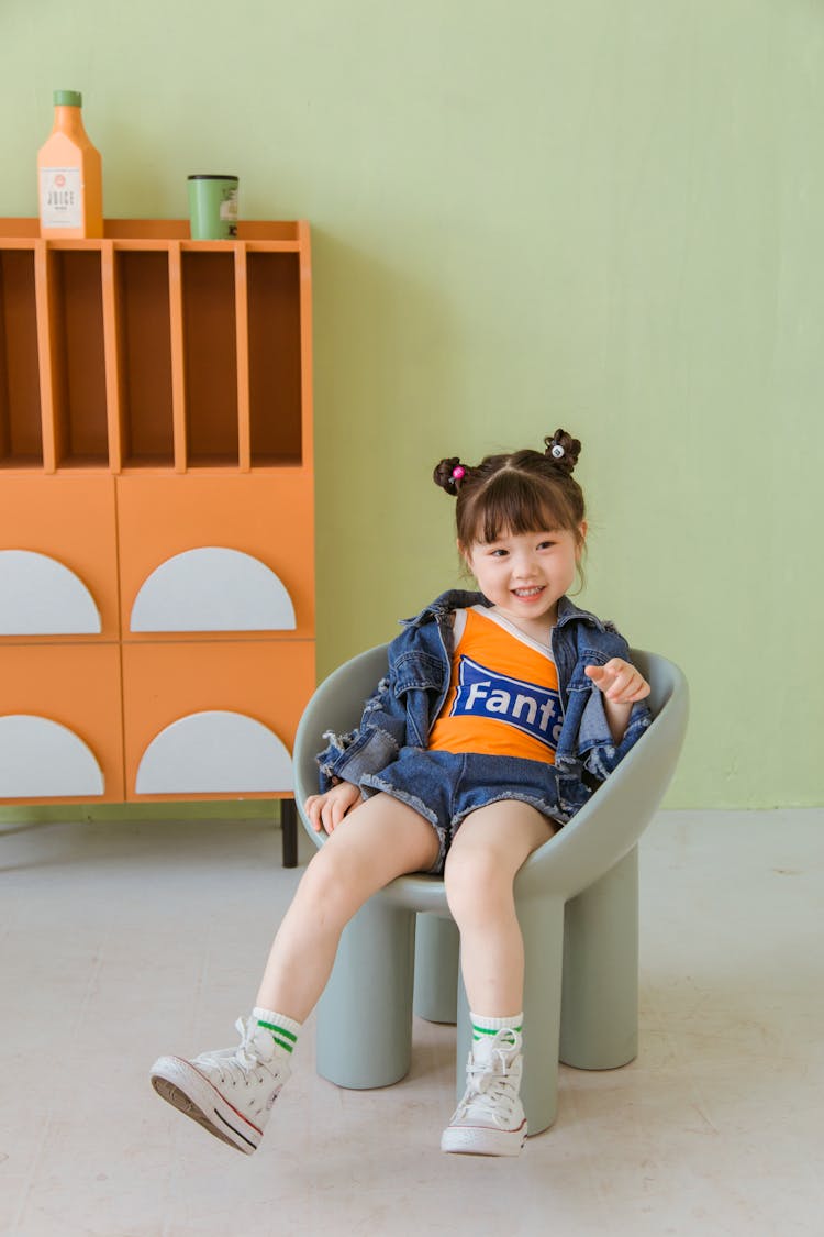 Smiling Girl Sitting On Chair