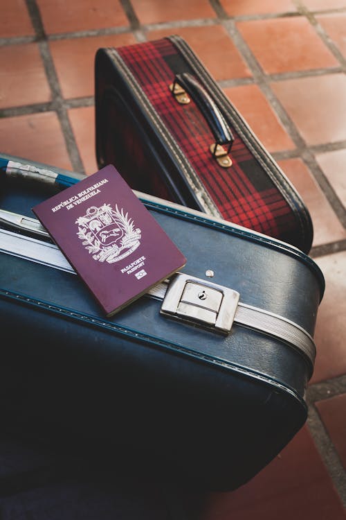 Venezuelan Passport Lying on Leathear Suitcase with a Lock