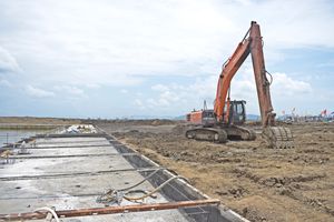 Orange excavator working a site