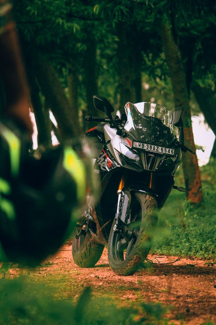 Black Motorbike Parked On Dirt Road