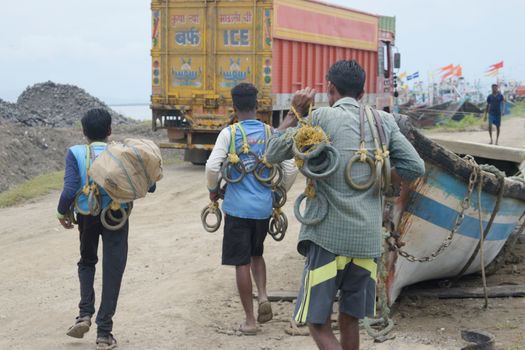 Fishermen Carrying Equipment to the Port