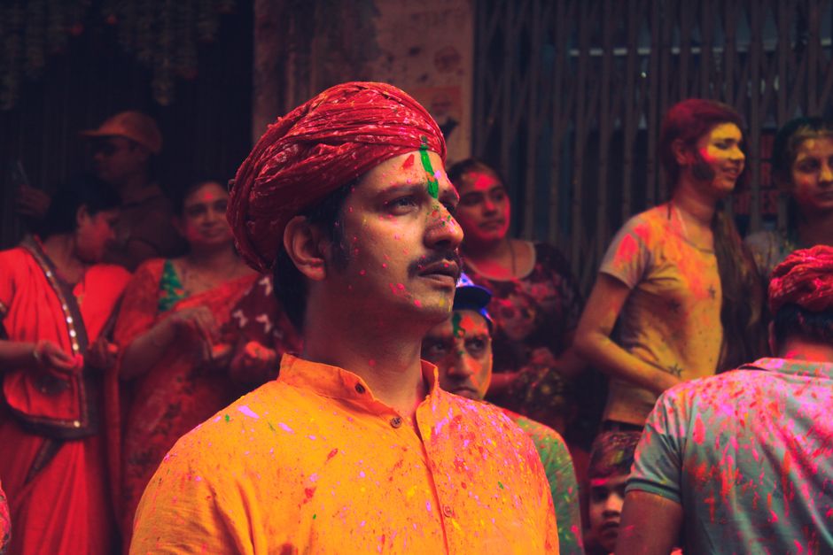 A lively scene from India's Holi festival, showcasing joyful people covered in vibrant colors.