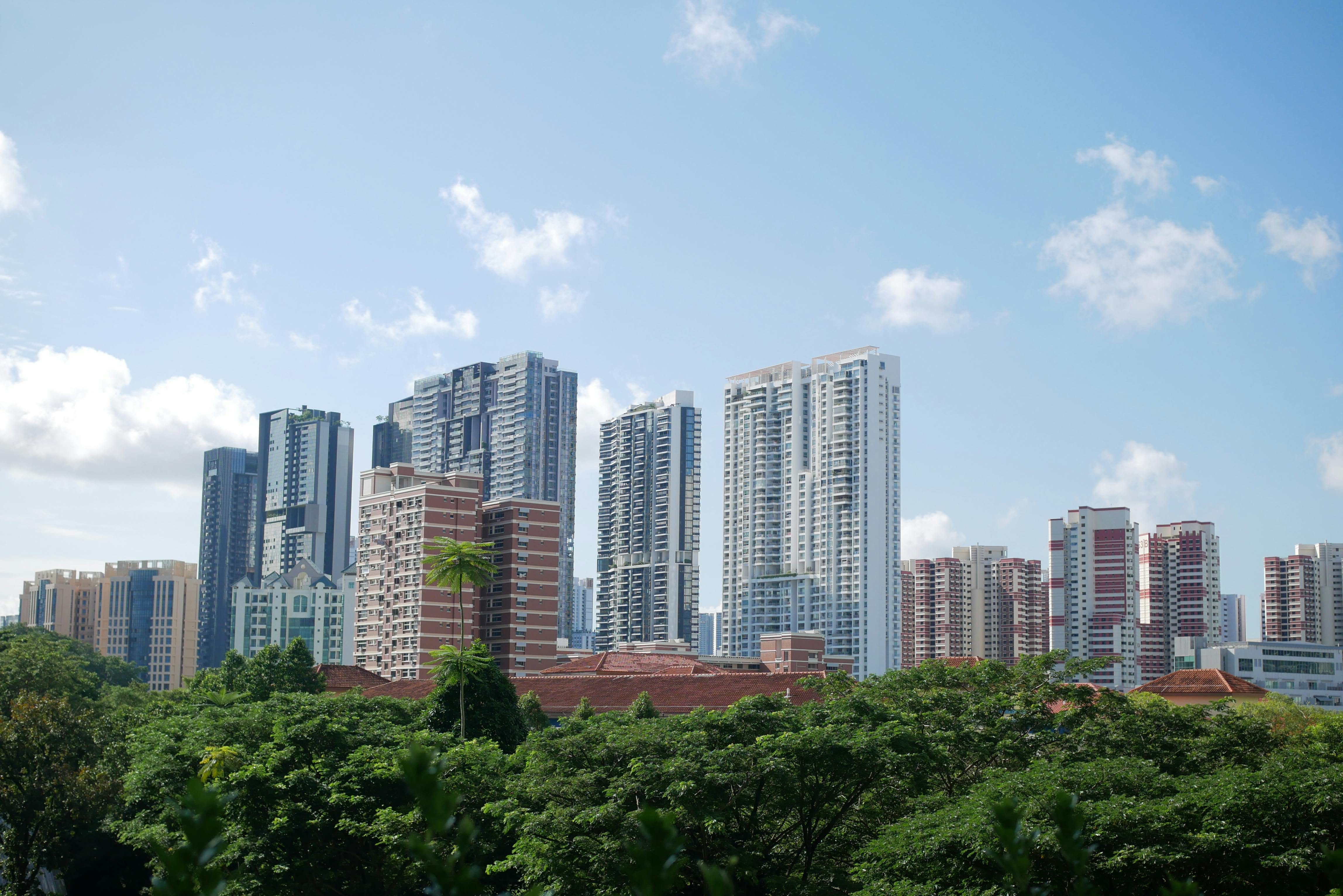 High Rise Buildings Under Blue Sky And White Clouds · Free Stock Photo