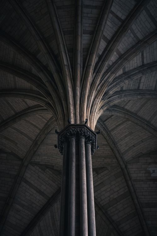 Free Intricate Gothic column and ceiling in a cathedral, showcasing exquisite architectural design. Stock Photo