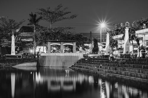 Grayscale Photography Of Stairs Beside Body Of Water