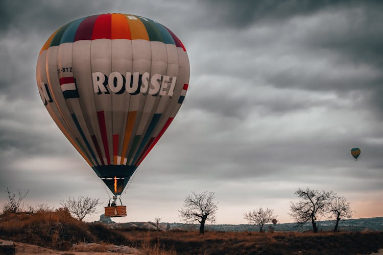 Yellow Green And Red Hot Air Balloon Under Gray Clouds