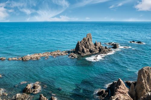 Free Explore the serene beauty of a rocky coastline with azure blue waters under a clear sky. Stock Photo